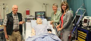 Colin and Lois Pritchard and their daughter Alison Moscrop check out the 'SimMan 3G' patient simulator, now located in the Pritchard Simulation Centre at the Clinical Academic Campus.