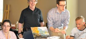 Medical student Maksim Parfyonov, second from right, leads the weekly art class with Connect residents Amadee Hollowink, Glen O’Connor, and Matthew McKay.